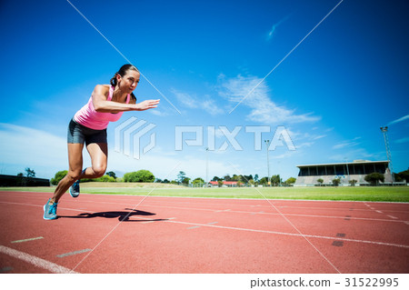 Female athlete running on the running track Female athlete running on the running track 31522995