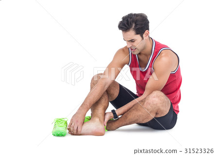 Male athlete with foot pain on white background 31523326