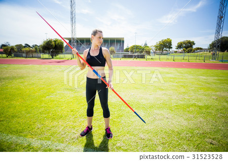 Female athlete holding a javelin 31523528