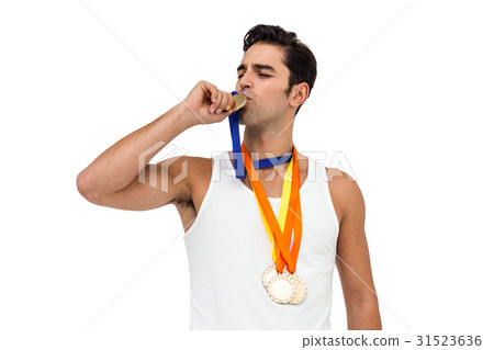 Happy athlete kissing medal 31523636