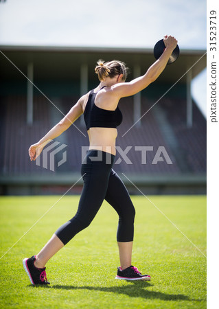 Female athlete about to throw a discus Female athlete about to throw a discus 31523719