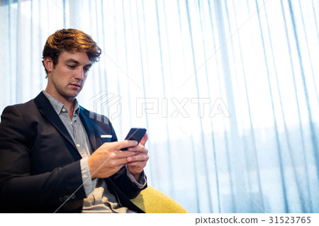 Businessman using a smartphone Businessman using a smartphone 31523765