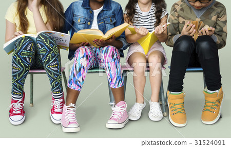 Diverse group of kids sitting in a row reading books Diverse group of kids sitting in a row reading books 31524091