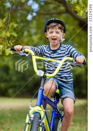 Portrait of smiling boy riding a bicycle Portrait of smiling boy riding a bicycle 31524399