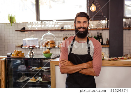Waiter standing with arms crossed Waiter standing with arms crossed 31524874