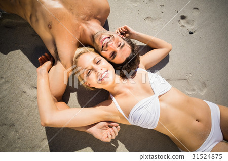Couple lying on beach 31524875
