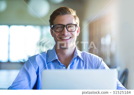 Portrait of smiling man using laptop Portrait of smiling man using laptop 31525184