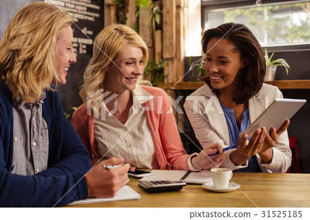 Partners interacting with tablet computer and calculator Partners interacting with tablet computer and calculator 31525185