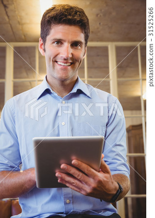 Business man posing with his tablet Business man posing with his tablet 31525266
