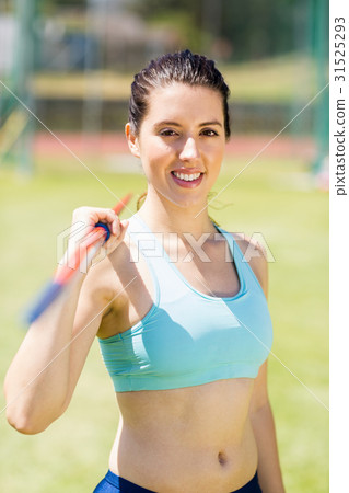 Portrait of female athlete holding a javelin 31525293