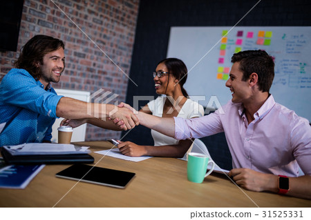 Group of hipster interacting and handshaking 31525331