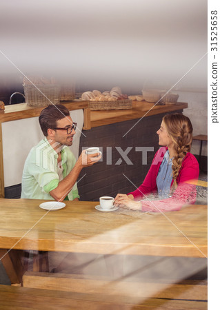 Couple interacting while drinking a coffee 31525658
