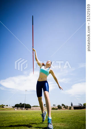 Female athlete throwing a javelin 31525939