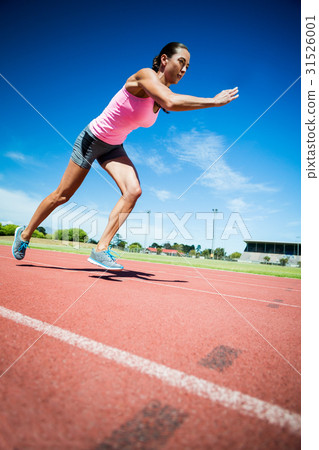 图库照片 female athlete running on the running track