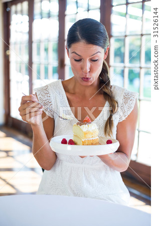 Woman having a pastry in restaurant Woman having a pastry in restaurant 31526144