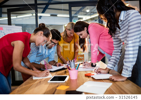Casual business team writing in notebooks Casual business team writing in notebooks 31526145
