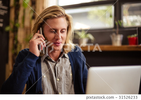 Hipster on the phone alone 31526233