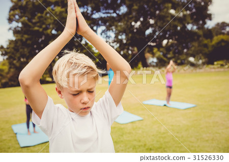 Close up view of child doing yoga with friends Close up view of child doing yoga with friends 31526330