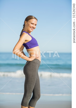 Portrait of beautiful woman listening music while exercising 31526340