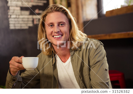 Happy man holding a cup of coffee Happy man holding a cup of coffee 31526382