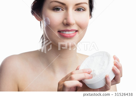 Woman applying a cream 31526438