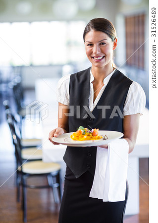 Waitress holding plate in a restaurant Waitress holding plate in a restaurant 31526489