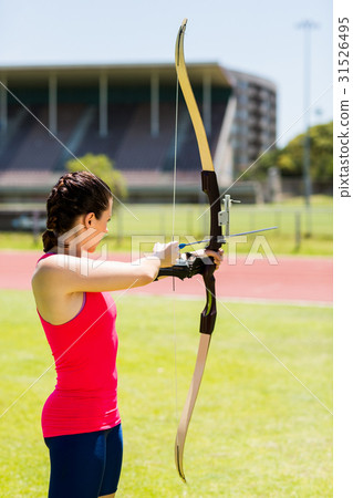 Female athlete practicing archery 31526495