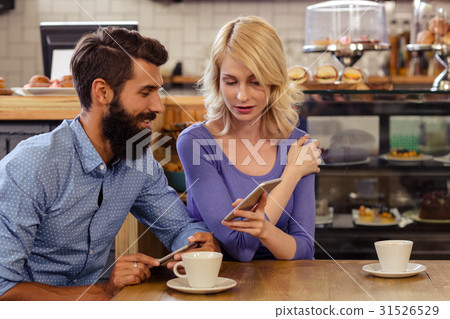 Couple using smartphones Couple using smartphones 31526529
