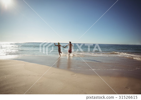 Couple running on beach Couple running on beach 31526615