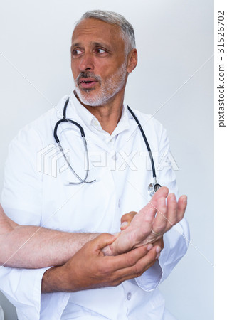 Male doctor giving palm acupressure treatment to the patient Male doctor giving palm acupressure treatment to the patient 31526702