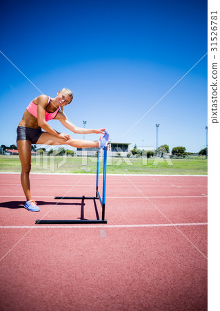 Portrait of female athlete warming up in stadium Portrait of female athlete warming up in stadium 31526781