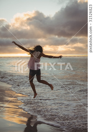 Woman jumping on the beach Woman jumping on the beach 31526823