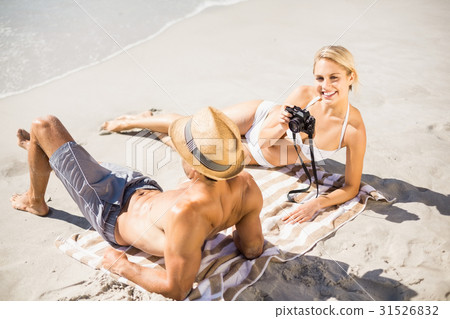 Young couple lying on beach 31526832