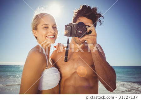 Couple clicking photographs from camera Couple clicking photographs from camera 31527137