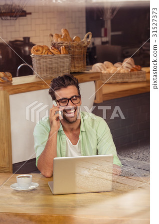 Hipster on the phone alone 31527373