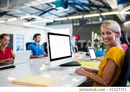 Casual business people working on computer Casual business people working on computer 31527751
