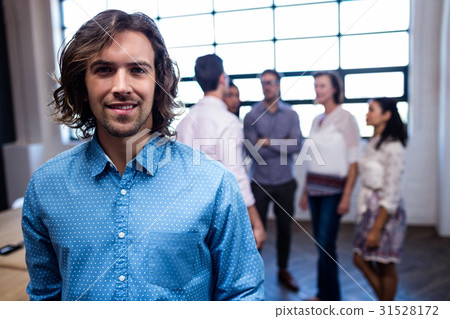 Portrait of a hipster and group of coworkers Portrait of a hipster and group of coworkers 31528172