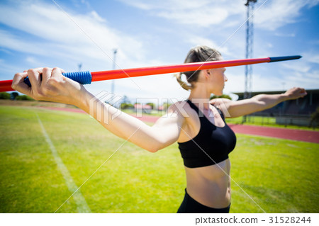 Female athlete about to throw a javelin 31528244
