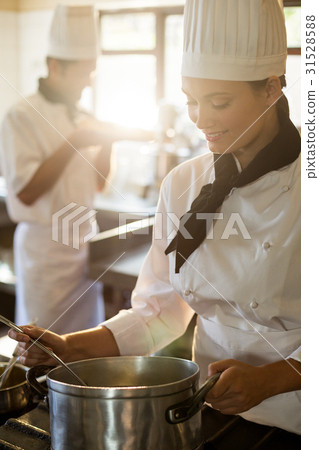 Happy head chef cooking at stove 31528588