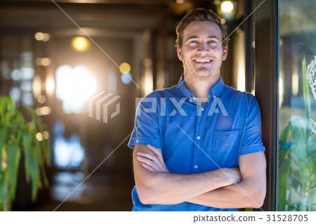 Portrait of smiling man standing with arms crossed 31528705