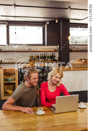 Couple using a laptop Couple using a laptop 31529036