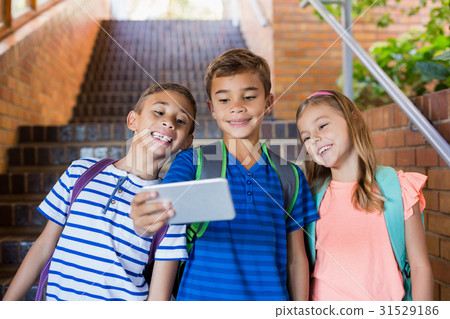 School kids taking selfie from mobile phone 31529186
