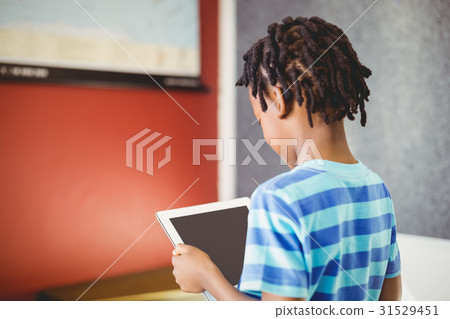 Schoolboy using digital tablet in classroom 31529451