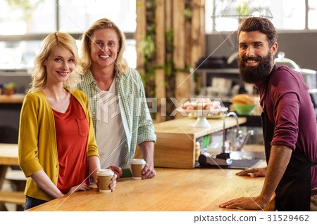 Portrait of a seller with customers Portrait of a seller with customers 31529462