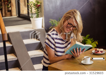 Woman reading a book sitting Woman reading a book sitting 31529603