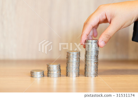 Hands stacking money for growing chart of coins. 31531174