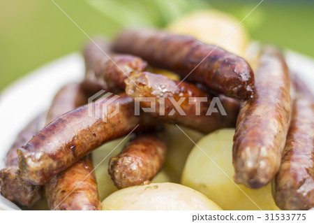 Grilled sausages with a boiled potatoes on a plate Grilled sausages with a boiled potatoes on a plate 31533775