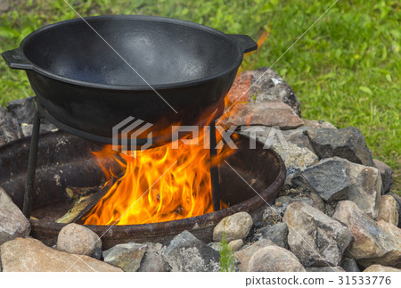 The cauldron on the fire. The pot on the fire The cauldron on the fire. The pot on the fire 31533776