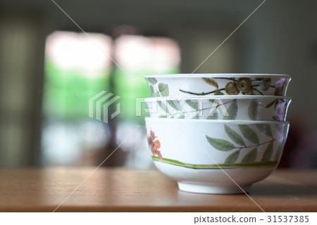 Bowls on a wooden desk and living room background Bowls on a wooden desk and living room background 31537385