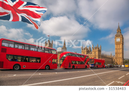 London with red buses against Big Ben in England 31538483